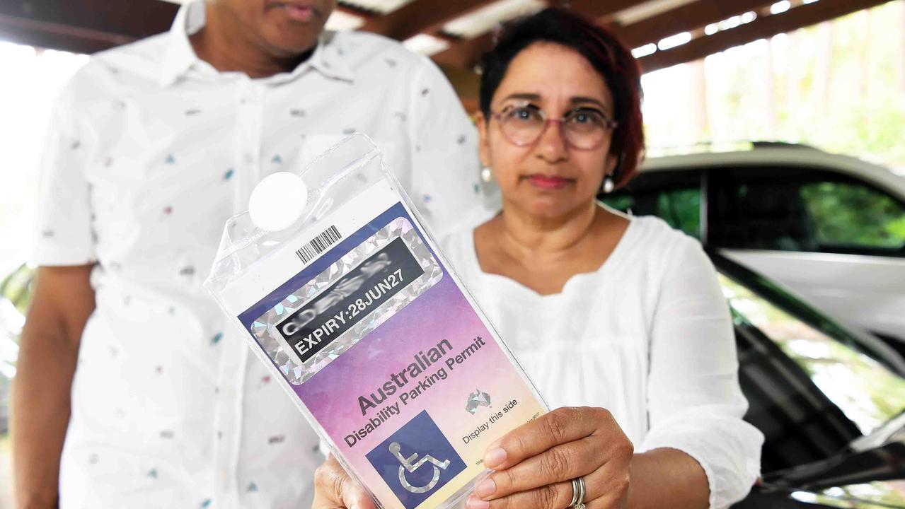 Vino and her husband Dhushan Illesinghe with their disability permit. Pictured: Patrick Woods.