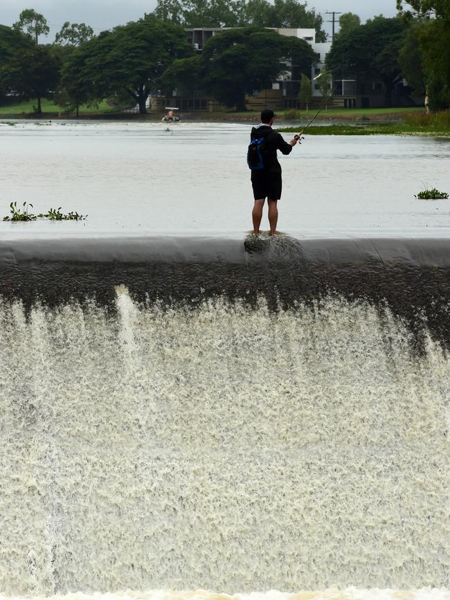 Wet weather in Townsville. People fish as Black Weir flows over. Picture: Evan Morgan