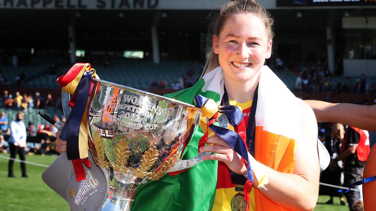 Irish recruit Ailish Considine holds up Adelaide’s 2022 AFLW premiership cup.