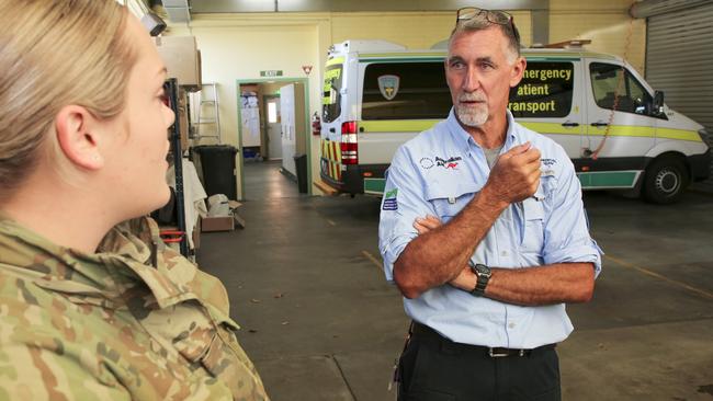 AUSMAT Paramedic, Mr Peter Jones, engages with an Australian Army soldier, from No. 26 Transport Squadron, during a familiarisation of the Burnie Ambulance Station in Tasmania, during COVID-19. Picture: DEFENCE MEDIA