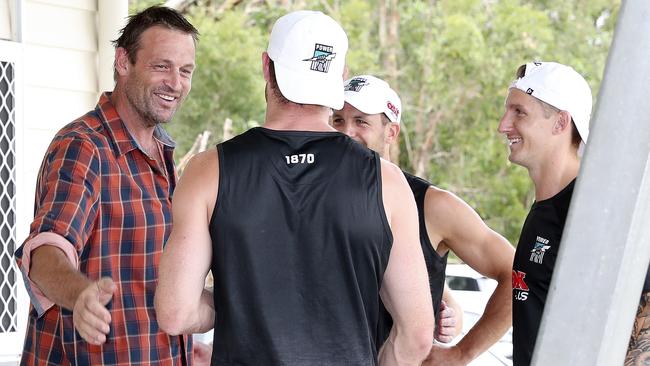 Travis Boak, Hamish Hartlett and Tom Jonas share a smile with former coach Matthew Primus in Noosa. Picture: Sarah Reed.