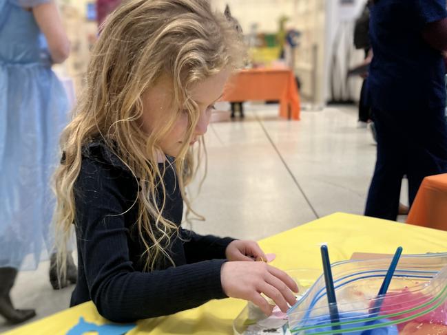 Hailey at one of the arts and crafts tables set up around the foyer.