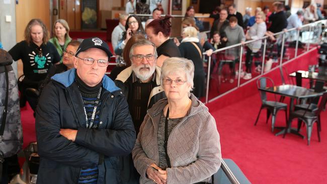 Footy fans Gary Harding, Joe Winiecki, and Maria Winiecki lining up for tickets at GPAC on Tuesday morning. Picture: Alison Wynd