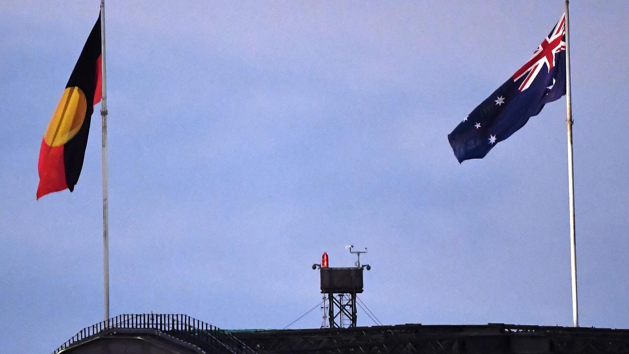 The Aboriginal and Australian flags flying from the Sydney Harbour Bridge. Picture: Saeed Khan/AFP