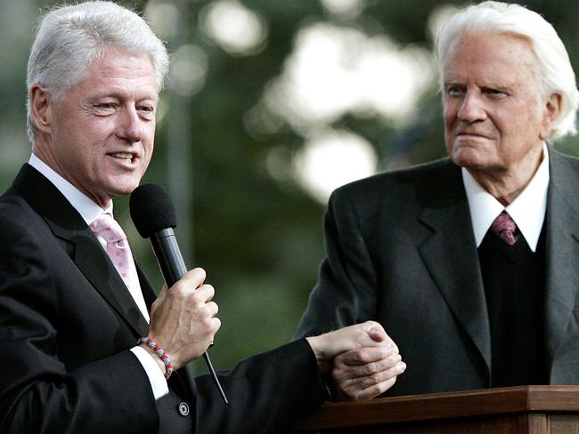 Former US President Bill Clinton speaks along with Billy Graham in 2005. Picture: AFP