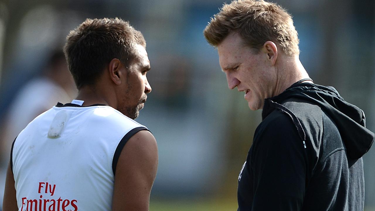 Andrew Krakouer speaks to Collingwood coach Nathan Buckley at training in 2012.