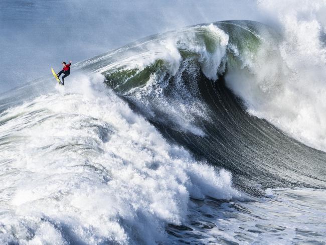 The waves in Portugal’s Nazaré are dangerous even for the bravest souls. Usually, surfers are brought to the waves by a jet ski that then waits to assist them out of the zone in case a giant wave breaks. This photo captures that exact moment. Picture: Andre Boto