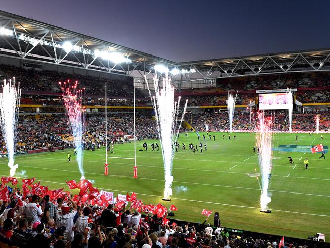 In this before-and-after composite image **TOP IMAGE** BRISBANE, AUSTRALIA - MAY 11: A general view of the stadium is seen during the round nine NRL match between the New Zealand Warriors and the St George Illawarra Dragons at Suncorp Stadium on May 11, 2019 in Brisbane, Australia. (Photo by Bradley Kanaris/Getty Images) **BOTTOM IMAGE** BRISBANE, AUSTRALIA - MARCH 20: Empty seats and a general view during the round 2 NRL match between the Brisbane Broncos and the South Sydney Rabbitohs at Suncorp Stadium on March 20, 2020 in Brisbane, Australia. (Photo by Jono Searle/Getty Images) TOP IMAGE ID# 1148354094 - BOTTOM IMAGE ID #1213648457