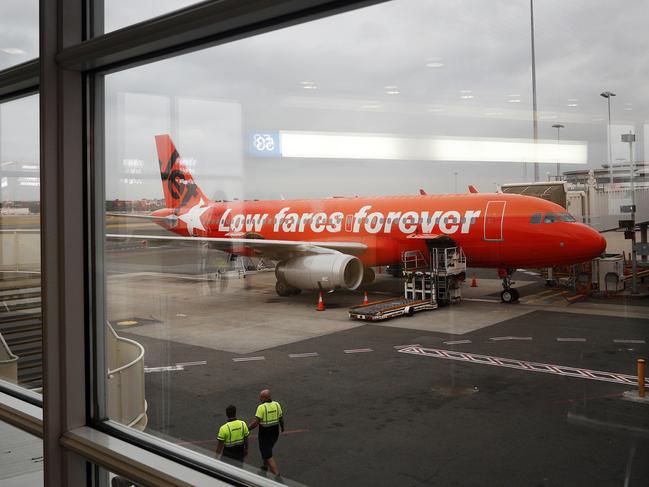 A Jetstar aircraft is seen at Sydney Airport on December 14. Jetstar has cancelled flights in anticipation of several hour blocks of strike action by pilots and ground crew over a pay and benefits dispute between the airline and the Transport Workers Union. Picture: Getty Images