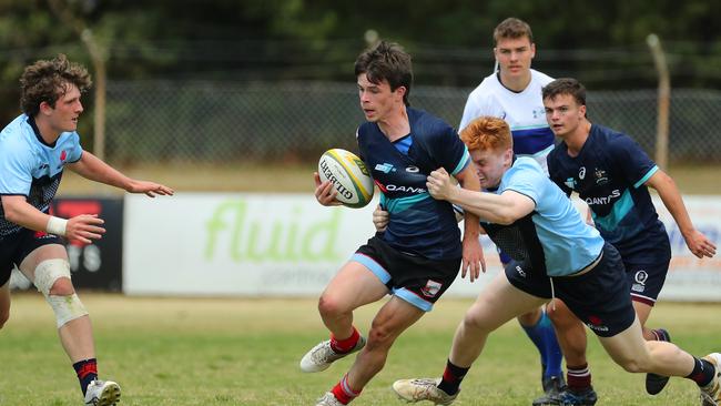 Caleb Murphy of the Barbarians is tackled during the match against NSW.