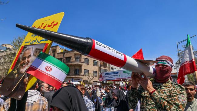 Iranians carry model missiles during the funeral for the IRCG members. Picture: AFP.