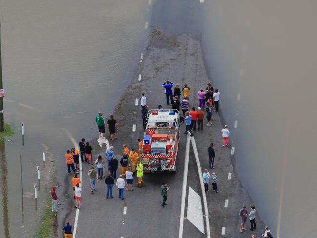 NSW SES workers searching for two people swept from the causeway on Cessnock Road, Maitland today. Picture: Adam Taylor