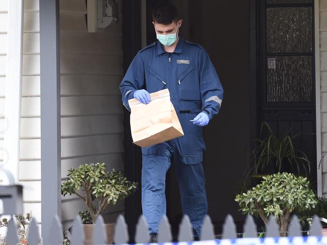 Police with evidence bags at the Spotswood home. Picture: Josie Hayden