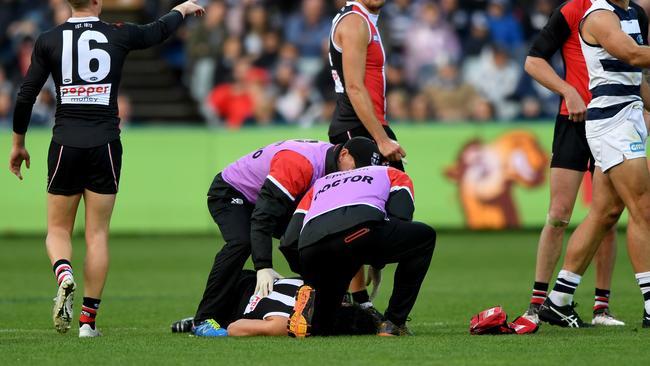 Dylan Roberton is helped by trainers after his first heart scare against Geelong last year.