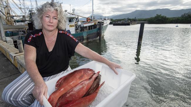 Owner of Torres Strait Seafoods in Cairns holds a box of coral trout that are now almost worthless. PIc by Brian Cassey