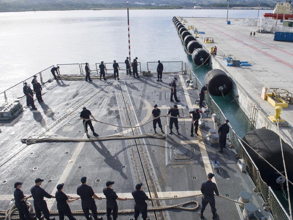 Sailors aboard the Arleigh Burke-class guided-missile destroyer USS Sterett (DDG 104) as the ship departs Naval Base Guam in 2017. Picture: AFP