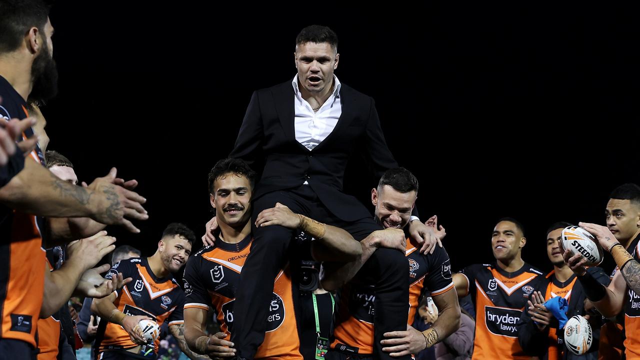 SYDNEY, AUSTRALIA - SEPTEMBER 04: Retiring Tigers player James Roberts is chaired off the field by Daine Laurie and Brent Naden of the Tigers during the round 25 NRL match between the Wests Tigers and the Canberra Raiders at Leichhardt Oval, on September 04, 2022, in Sydney, Australia. (Photo by Mark Kolbe/Getty Images)