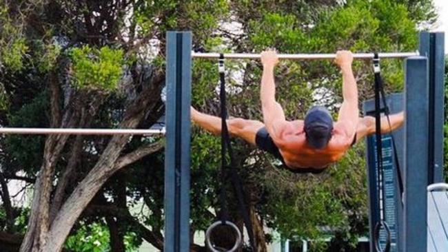 Tim hits the local park to work out (show off).