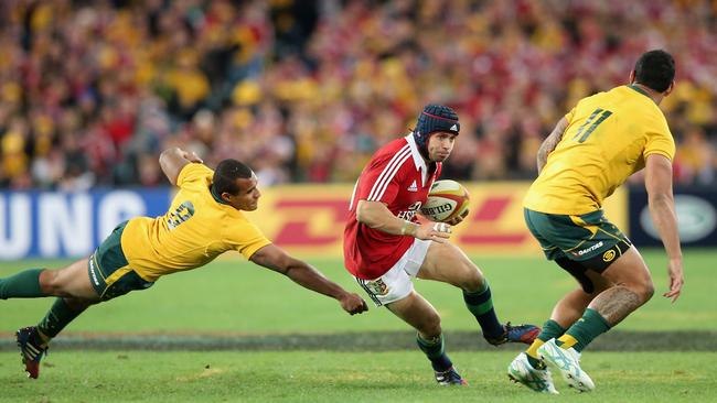 Leigh Halfpenny of the British and Irish Lions races clear of Wallaby Will Genia.