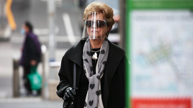 A woman waits at a tram stop in Melbourne on Wednesday. Picture: Ian Currie