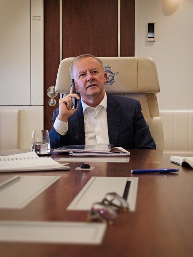 Anthony Albanese speaks to British Prime Minister Boris Johnson as he flies to Tokyo on Monday.