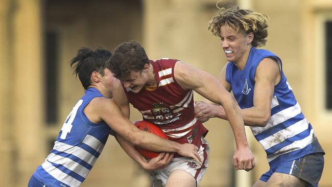 St Peter’s footy player Sam Dukalskis (far right) is one to watch when college football return this year. Picture: AAP/Dean Martin