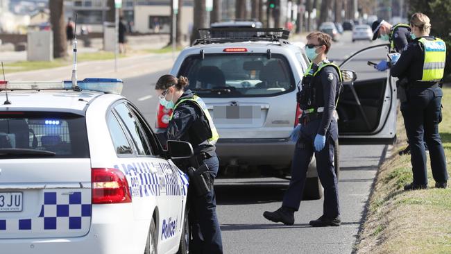 MELBOURNE, AUSTRALIA- NewsWire Photos SEPTEMBER 1, 2020: Police conduct roadside checks in Middle Park on he first day of spring as people are seen exercising along the foreshore during a stage four COVID-19 lockdown in Melbourne. Picture: NCA NewsWire/ David Crosling