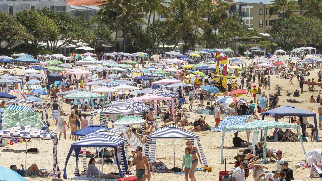 Holiday crowds pack in at Noosa Main Beach. Picture: Lachie Millard