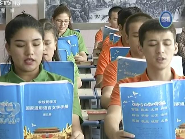 In this image from undated video footage run by China's CCTV via AP Video, young Muslims read from official Chinese language textbooks in classrooms at the Hotan Vocational Education and Training Center in Hotan, Xinjiang, northwest China. Chinaâ€™s state broadcaster CCTV put out a report Tuesday, Oct. 16, 2018, on a so-called vocational education and training center in Hotan, Xinjiang, with Muslim trainees telling the camera how they have been saved from dangerous and poor lives and how grateful they are to the authorities. (CCTV via AP Video)