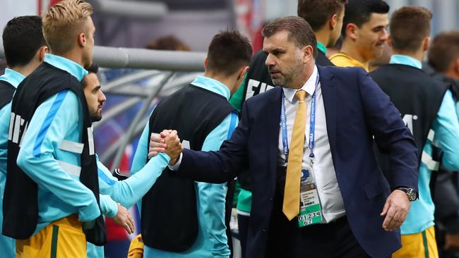 Ange Postecoglou manager of Australia shakes hands with his players.