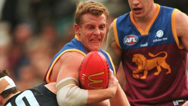 2000 Semi-Final. Brisbane Lions v Carlton. MCG. Michael Mansfield tackles Brisbane Lions Michael Voss, while Brisbane Lion Beau McDonald looks on.