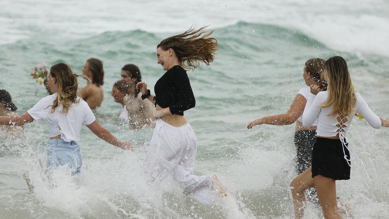 Family and friends of 16-year-old alleged stabbing victim Balin Stewart gather to pay tribute on his home beach at Buddina. Picture: Lachie Millard