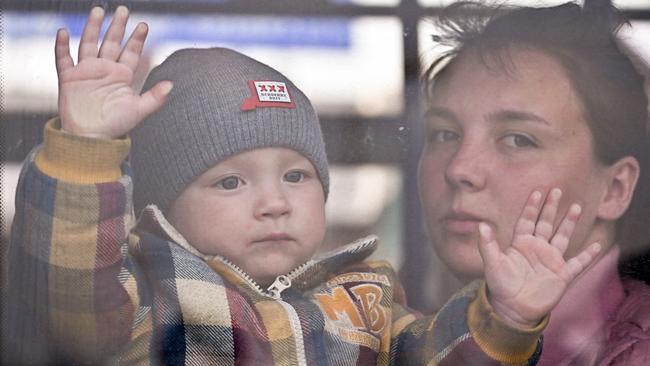 A women and child make their way through Poland’s Medyka border crossing on Wednesday. Picture: Getty Images