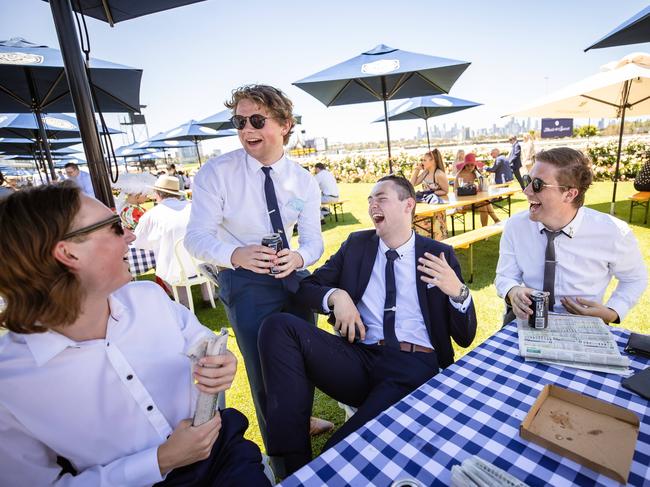 Punters watch the races from a trackside table. Picture: Jason Edwards