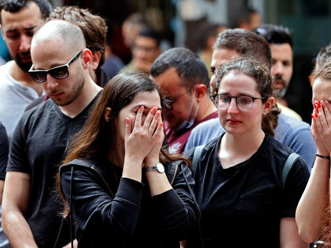 Israelis react at the site of a shooting attack the previous night at Dizengoff Street in the centre of Israel's Mediterranean coastal city of Tel Aviv on April 8, 2022. (Photo by JACK GUEZ / AFP)