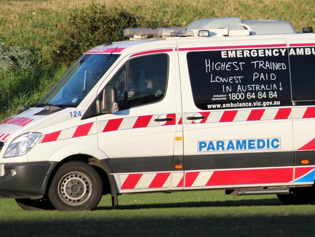 Category:News; Caption:At an under 16s football game in Essendon yesterday an ambulance was called for a player that laid motionless for 15 minutes after a marking contest. When the ambulance arrived most spectators and players were surprised it had been graffiti\'d with slogans relating to pay claims and the salaries of political leaders. (2nd pic); Read the terms and conditions:YesWEBSITE READER PICTURE HWTWayne Brasher , changingpockets@gmail.com, 0425892371,