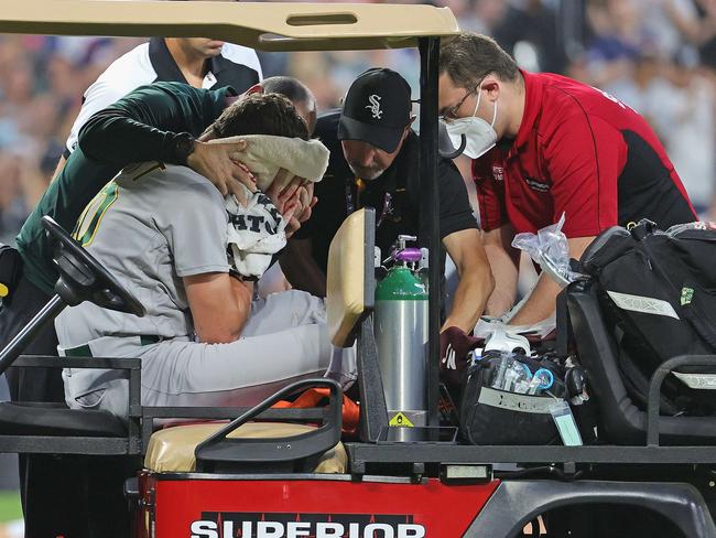 CHICAGO, ILLINOIS - AUGUST 17: Starting pitcher Chris Bassitt #40 of the Oakland Athletics is placed on a cart after being hit in the head by a line drive from Brian Goodwin of the Chicago White Sox in the second inning at Guaranteed Rate Field on August 17, 2021 in Chicago, Illinois.   Jonathan Daniel/Getty Images/AFP == FOR NEWSPAPERS, INTERNET, TELCOS & TELEVISION USE ONLY ==