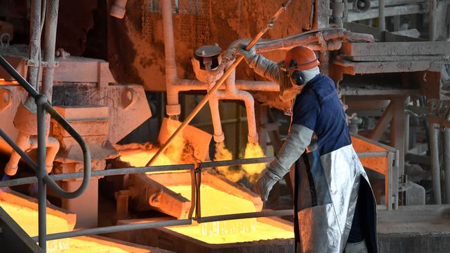 A worker handles molten copper at the at the Glencore Copper Smelter in Mount Isa. Picture: NCA NewsWire / Dan Peled