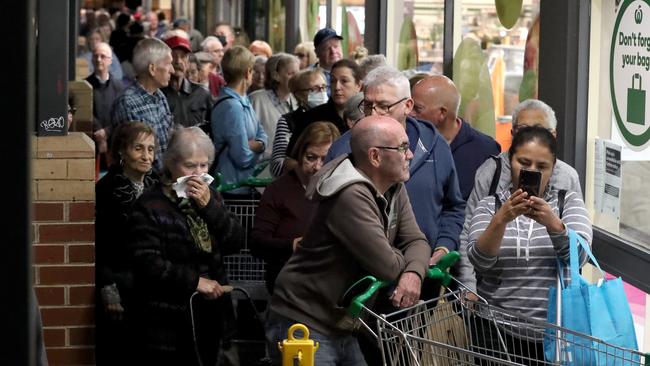 Shoppers wait for Woolworths to open in Moonee Ponds, in Melbourne’s inner northwest. Picture: David Geraghty