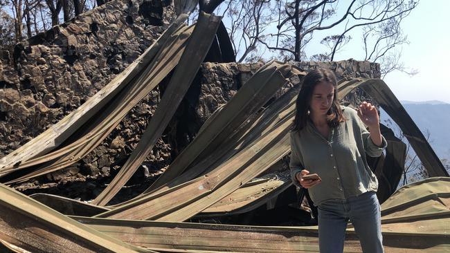 Lisa Groom’s daughter, Inari, in the wreck of the Groom family home, Alcheringa, at Binna Burra.