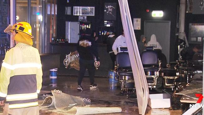 The driver lost control of his sports car as he was heading west on The Parade, crashing into a parked car and then the building. Picture: 7NEWS