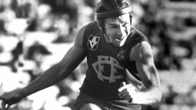 Garry Wilson wearing his famous helmet in action for Fitzroy.