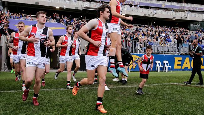 The Saints run out on to a wet Optus Stadium (Photo by Will Russell/AFL Photos via Getty Images)