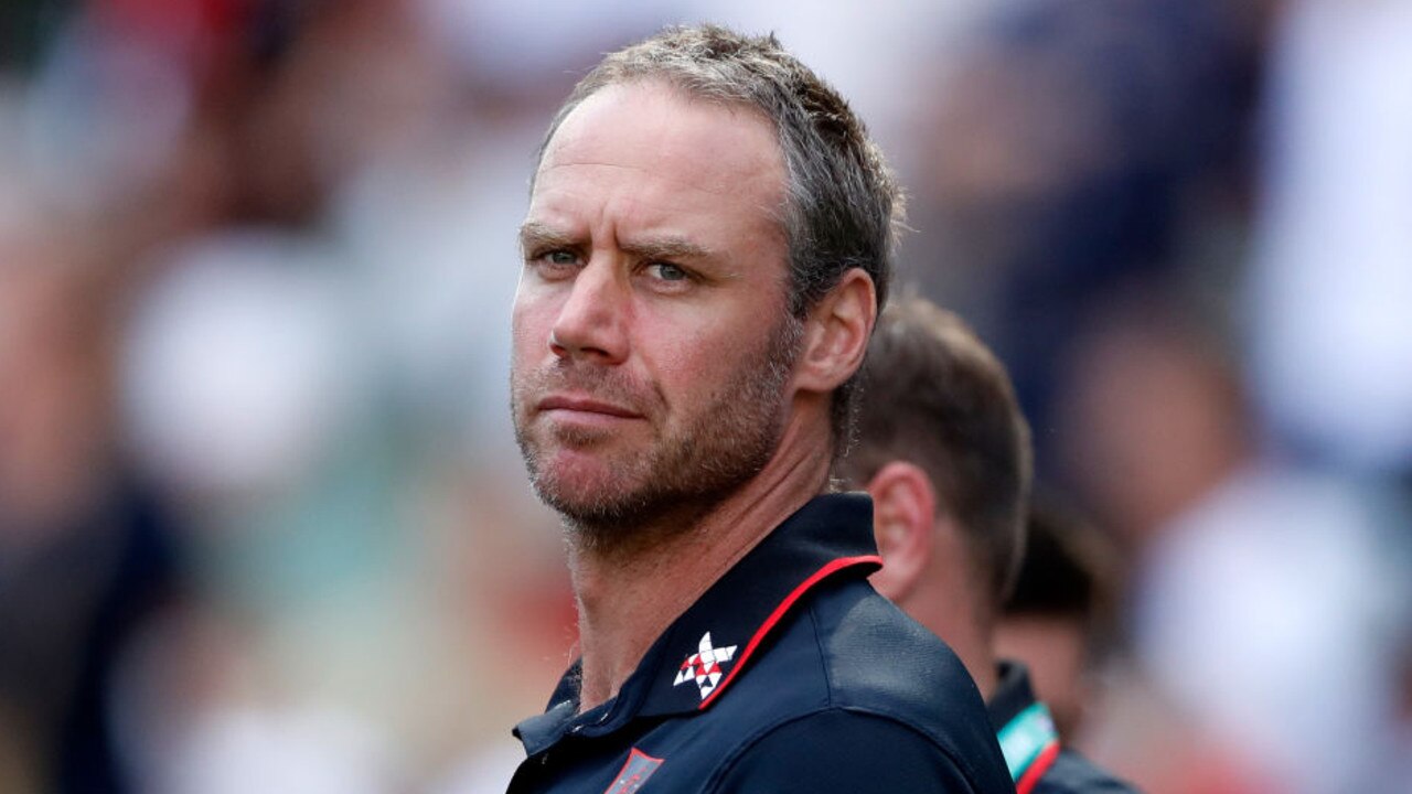 MELBOURNE, AUSTRALIA - MARCH 19: Ben Rutten, Senior Coach of the Bombers looks on during the 2022 AFL Round 01 match between the Geelong Cats and the Essendon Bombers at the Melbourne Cricket Ground on March 19, 2022 In Melbourne, Australia. (Photo by Dylan Burns/AFL Photos via Getty Images)