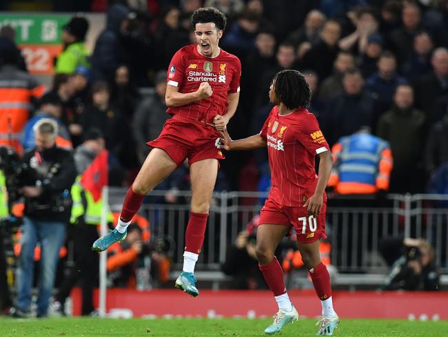 Liverpool's English midfielder Curtis Jones (L) celebrates after scoring the opening goal of the English FA Cup third round football match between Liverpool and Everton at Anfield in Liverpool, north west England on January 5, 2020. (Photo by Paul ELLIS / AFP) / RESTRICTED TO EDITORIAL USE. No use with unauthorized audio, video, data, fixture lists, club/league logos or 'live' services. Online in-match use limited to 120 images. An additional 40 images may be used in extra time. No video emulation. Social media in-match use limited to 120 images. An additional 40 images may be used in extra time. No use in betting publications, games or single club/league/player publications. /