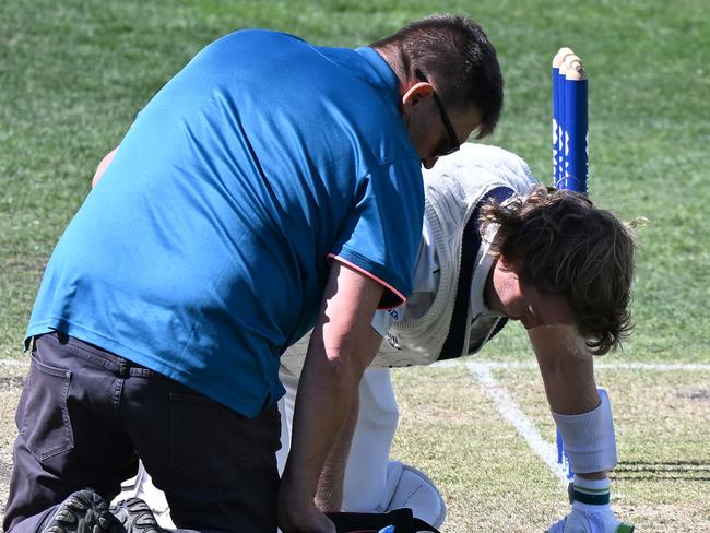 Pucovski is treated by medical staff after his most recent blow from Tasmania’s Riley Meredith during the Sheffield Shield. Picture: Steve Bell/Getty Images