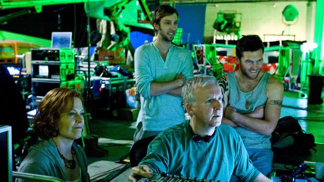 Writer-director James Cameron, right, reviews a scene with actors Sigourney Weaver, Joel David Moore and Sam Worthington during the filming of the original Avatar.