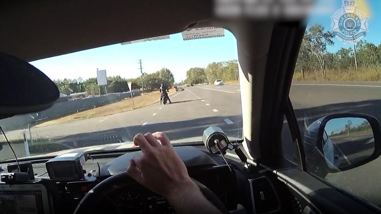 A motorcyclist is pulled over by police.