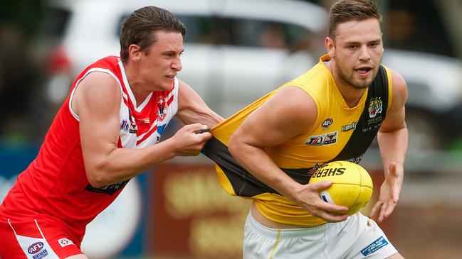 Waratah’s Jacob Schaper tries to stop Nightcliff opponent Liam Evans in their NTFL clash at Gardens Oval. Picture GLENN CAMPBELL