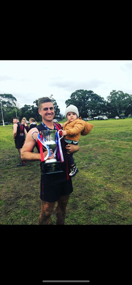 Shannon Henwood with his boy Sonny after the 2019 grand final.